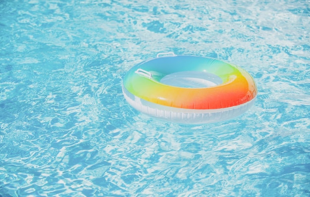 Water background Pool float ring floating in a refreshing blue swimming pool Summer background