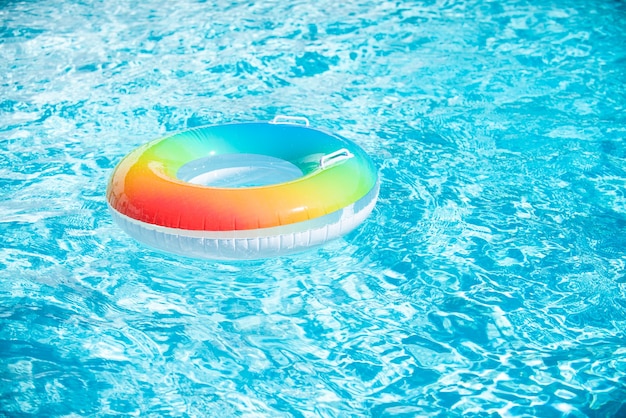 Water background. Pool float, ring floating in a refreshing blue swimming pool. Summer background.