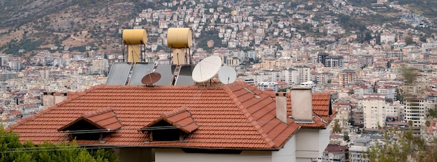 Water barrels heated by solar panels installed on house roof, banner