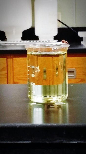 Water in beaker on table inside laboratory