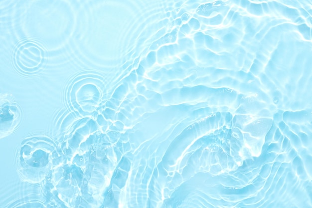 Water blue surface abstract background Waves and ripples of cosmetic moisturizer with bubbles