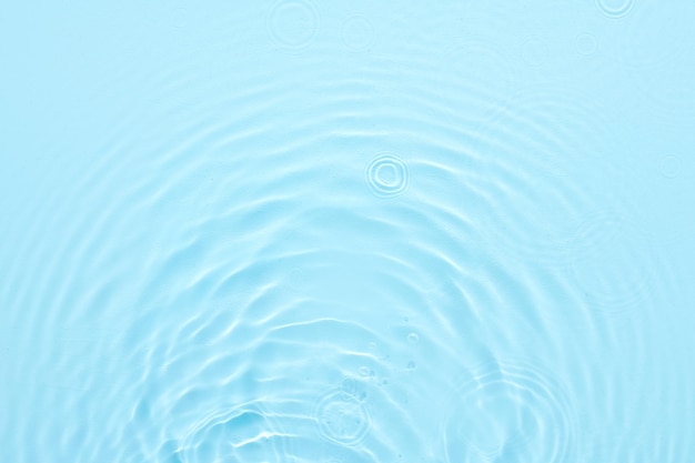 Water blue surface abstract background Waves and ripples of cosmetic moisturizer with bubbles