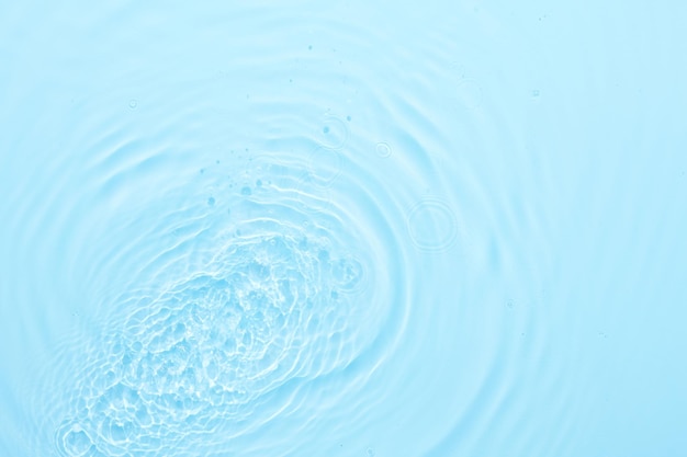 water blue surface abstract background waves and ripples texture of cosmetic aqua moisturizer with bubbles