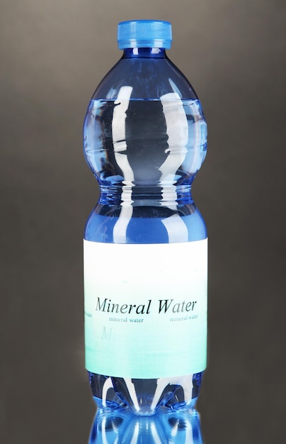 Water bottle with label on grey background