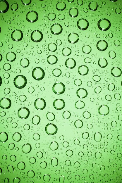 Water bubble on green glass.