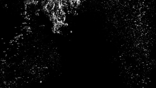 Water bubbles floating after splash underwater and black background which represent freshness of carbonate drink such as cola or soda and refreshing feeling of food product and texture.