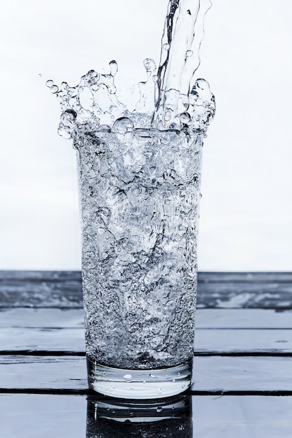 Water to drink poured into a glass 