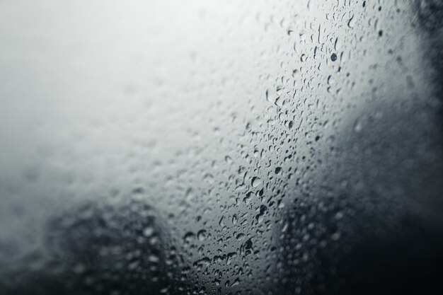 Water droplets on car windshield on rainy day