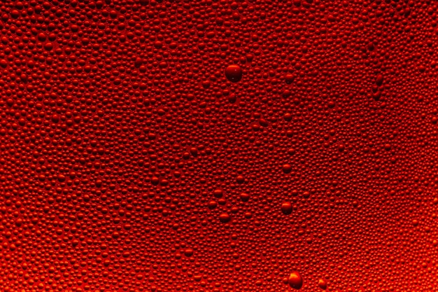 Water droplets on the glass with a red illumination