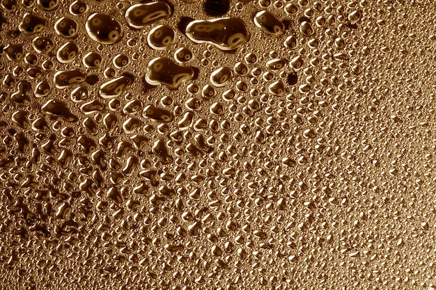 Water droplets on golden metal a beautiful unusual texture