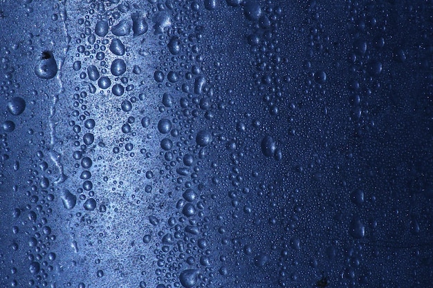 water droplets on the metal surface. Blue abstract background