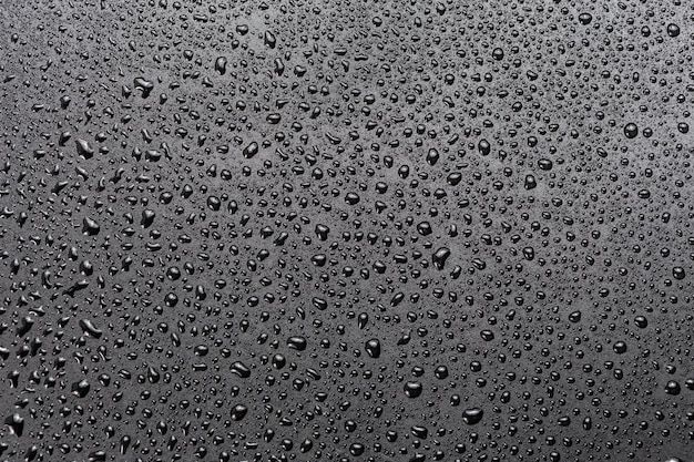 抽象的な平らな黒い疎水性表面マクロ背景に水滴