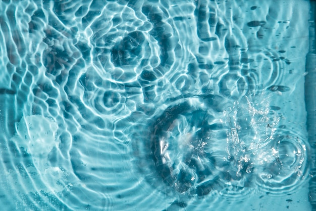 Water drops on a blue background a background for demonstrating cosmetics