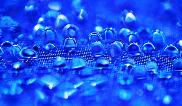 Water drops on the blue textured surface.