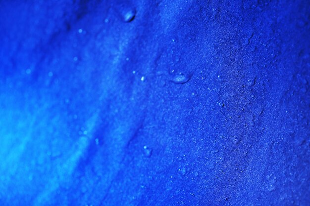 Water drops on color surface background macro view