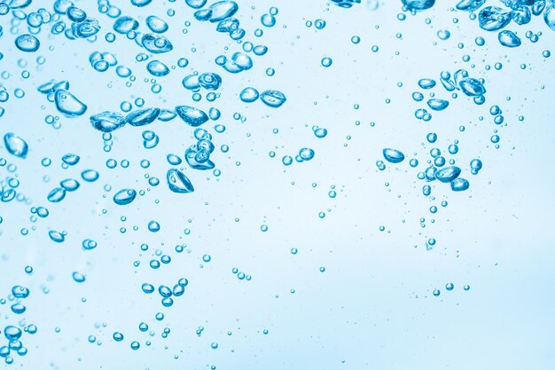 Water drops on glass against blue sky