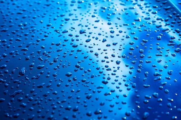 Water drops on metal blue background