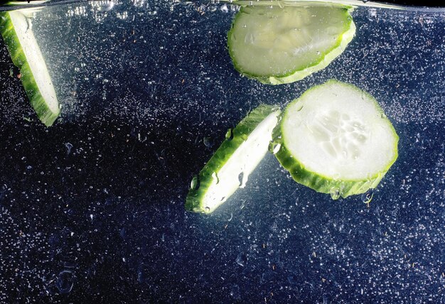 Water drops on ripe cucumber Fresh vegetables background with copy space for your text Vegan concept