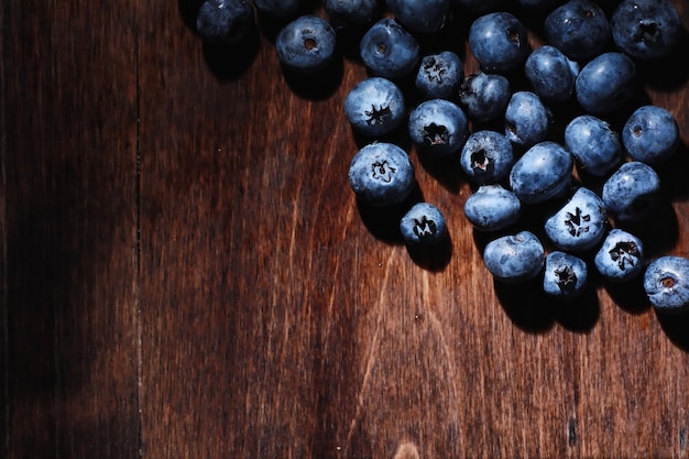 Water drops on ripe sweet blueberry. Fresh blueberries background with copy space for your text. Vegan and vegetarian concept. Macro texture of blueberry berries.Texture blueberry berries close up