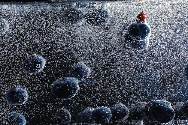 Water drops on ripe sweet blueberry. Fresh blueberries background with copy space for your text. Vegan and vegetarian concept. Macro texture of blueberry berries.