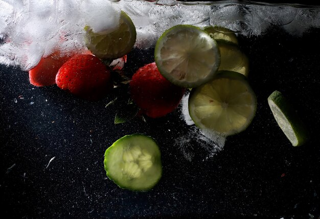 Water drops on ripe sweet fruits and berry. Fresh fruits background with copy space for your text. Vegan and vegetarian concept.