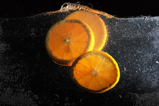 Water drops on ripe sweet orange. Fresh mandarin background with copy space for your text. Vegan and vegetarian concept.
