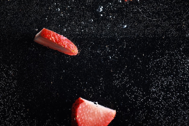 Water drops on ripe sweet strawberry. Fresh berry background with copy space for your text. Vegan food concept.