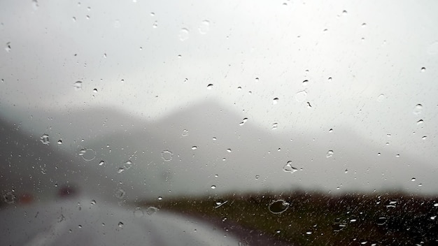 Water drops on windshield on a rainy day in the mountains