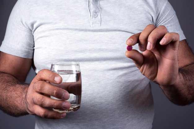 water and drug in man hand