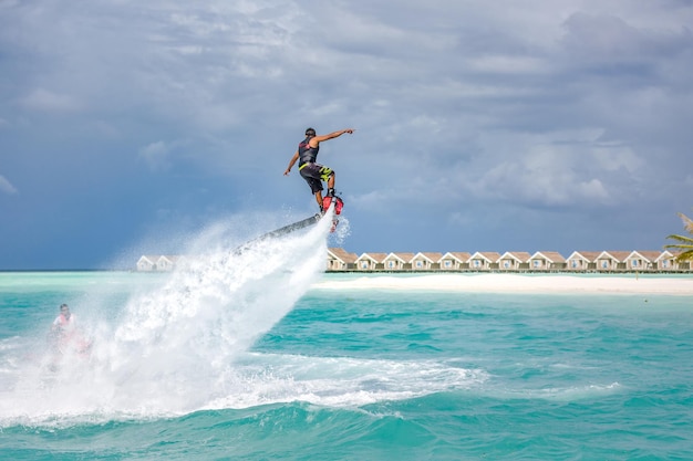 Water extreme sport, summer sea, tropical weather with outdoors active people enjoying water sport