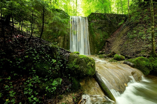 water falling into river from rock