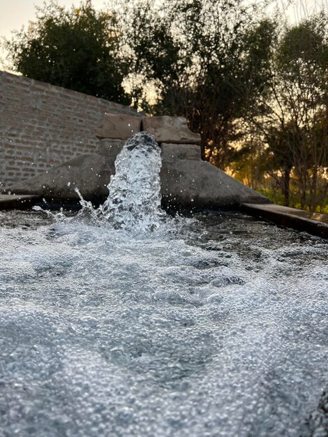 A water feature with a waterfall in the background