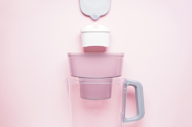 Water filter jug on a pink background Top view