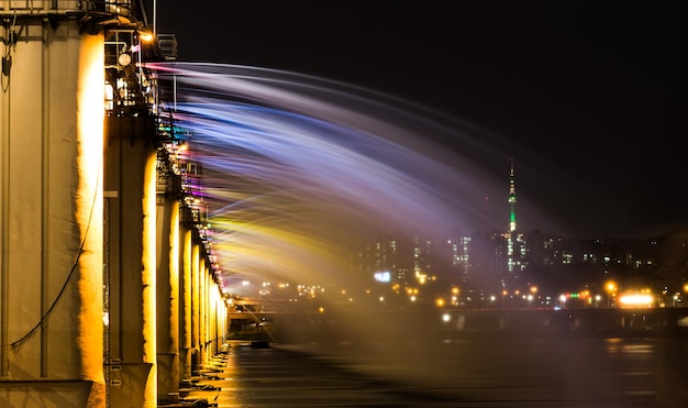 water flowing from illuminated banpo bridge against sky at night