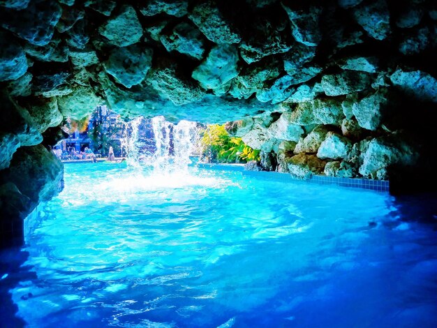 Water flowing through rocks in swimming pool