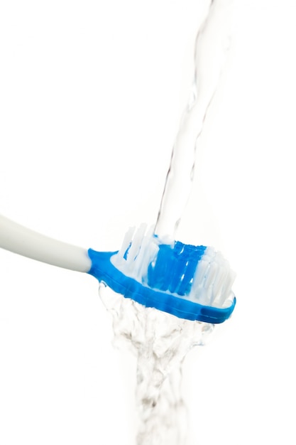 Water flowing on a toothbrush