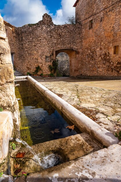 Water fountain made of ancient stone in the medieval village of Palazuelos Guadalajara