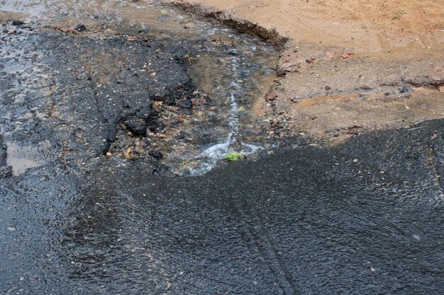 Water from rain flows along the road