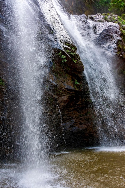 Water from the waterfall splashing through the rocks into a water well in Minas Gerais Brazil