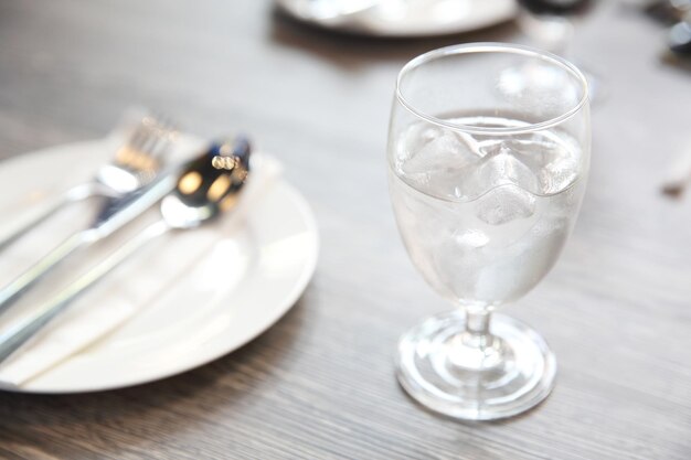 Water in glass in wood background