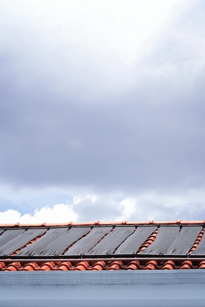 Water Heating System on the Roof of the House in a Sunny and Cloudy Day