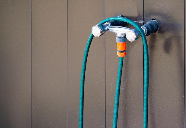 Water hose hanging on a water tap