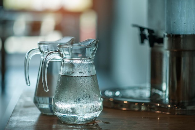 Photo water in jugs on table at home