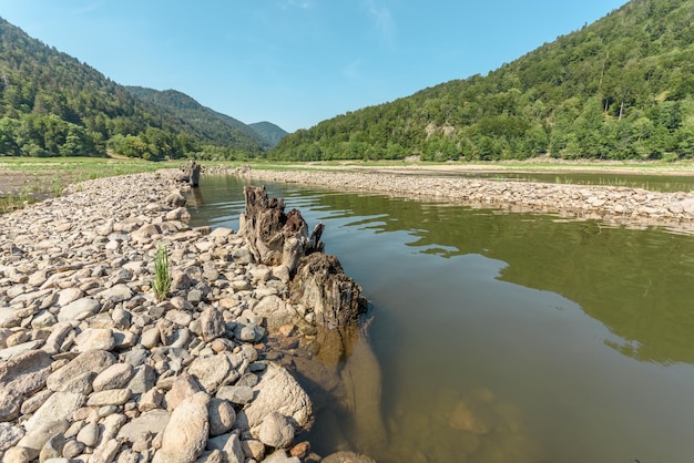 Water level drops in mountain lake in summer