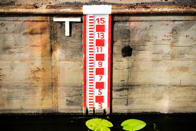 Water level gauge or water tide level measurement scale or water lever indicator. 