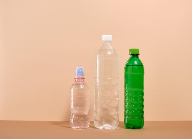 Water in plastic bottles on a beige background Water balance