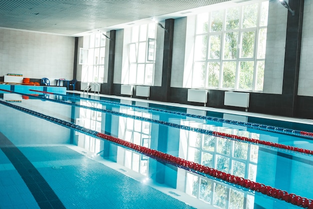 A water pool with blue transparent clear water, on which bright sunlight shines