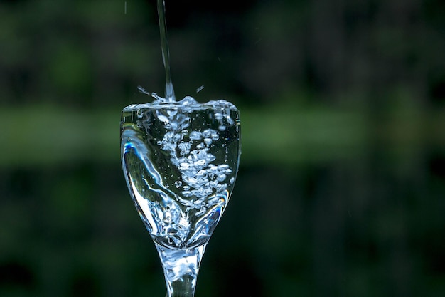 Foto acqua versata nel bicchiere di vino