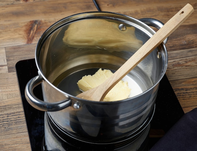 Water, salt and butter in a pot for making eclair dough