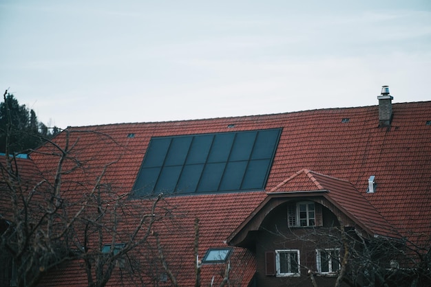 Water solar collector on a red metal roof Solar thermal and solar panel for hot water